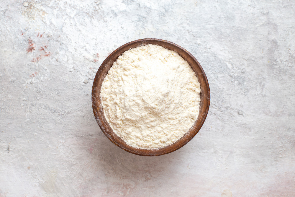 top-view-white-flour-inside-plate-white-background-flour-dust-dough-bake-raw